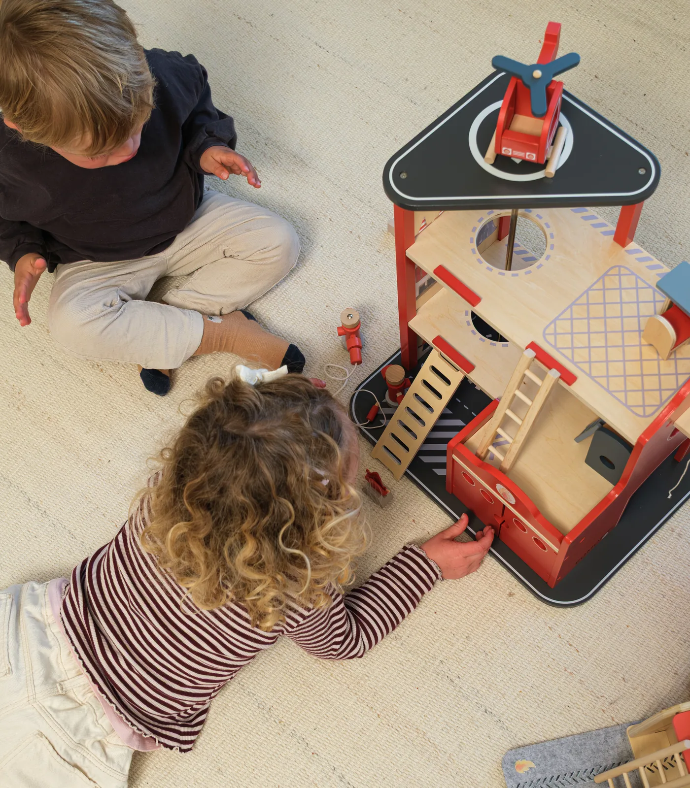 Children playing with the AW26 fire station